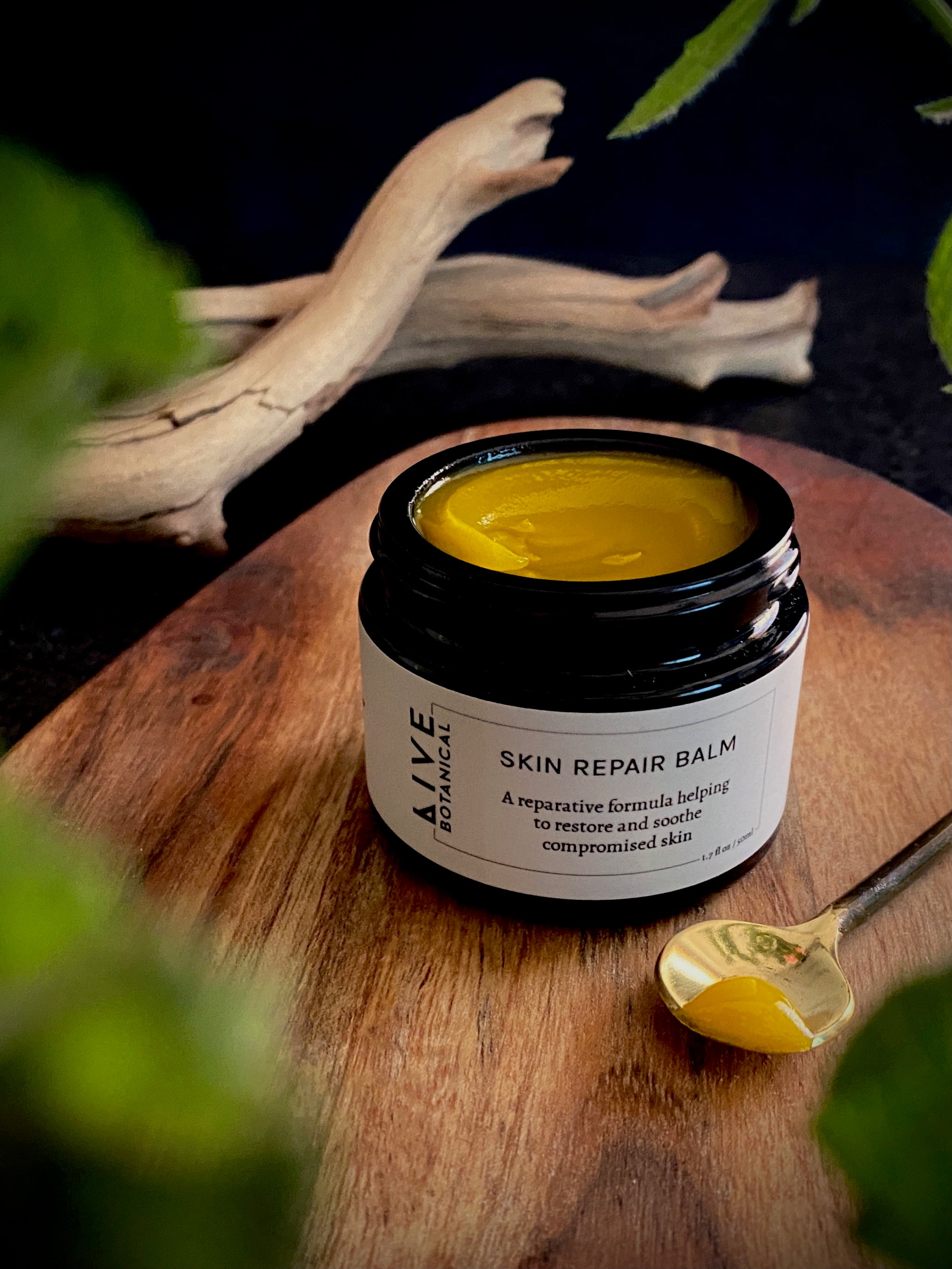 Open jar of Skin Repair Balm with soft golden texture